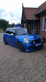 My beautiful MINI  - Page 1 - East Anglia - PistonHeads - The image shows a striking blue Mini Cooper parked on a gravel driveway in front of a house. The car is positioned on the left side of the image, facing the camera. The gravel driveway extends in front of the car to the house, suggesting a residential setting. The house, visible in the background, has a classic architectural style. The overall scene suggests a calm, suburban setting.