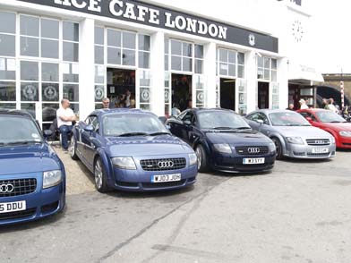 New Bristol member - Page 1 - South West - PistonHeads - The image shows a row of four blue Audi cars parked closely together in front of a building, which is identified as a restaurant named "Rice Cafe London". Behind the cars, there's a large glass fronted on the left side. A few people are standing around, and one of the people is sitting on a bench. In the background, a red car can be seen to the right.