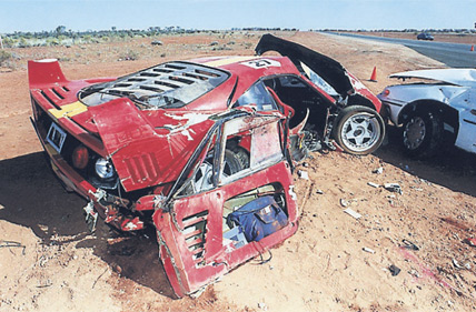 A motorcycle parked on the side of a road - Pistonheads - The image captures a striking scene on a dry, dirt road. Two red cars have gotten into a rather unfortunate incident, both with their hoods shattered, suggesting a powerful collision. The damaged cars, with one appearing to still be moving towards the other, take up most of the image, their bright red color contrasting sharply with the muted tones of the road. This image likely captures the aftermath of a serious car accident, with the cars appearing fully destroyed and the scene exuding an air of desolation.