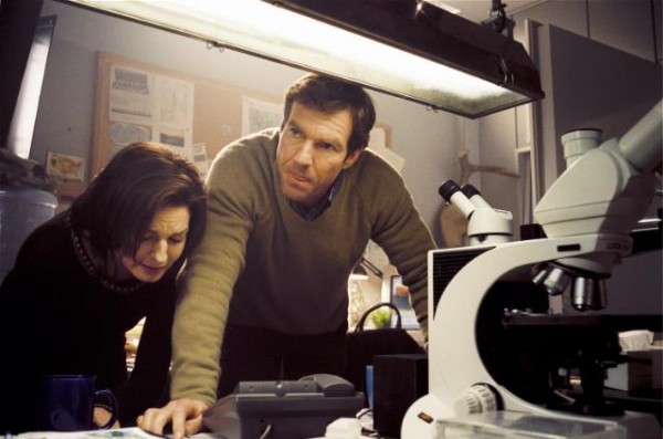 A man and a woman standing in a kitchen - Pistonheads - The image depicts a man and a woman engaged in an activity around a scientific apparatus, which appears to be a microscope. The man, with a focused and determined expression, is leaning over the microscope, while the woman's hands are on a piece of paper that may be a notebook or a plan. Surrounding them is a scattered desk with various laboratory equipment items. The ambiance suggests a shared research project or a scientific experiment being prepared or carried out.