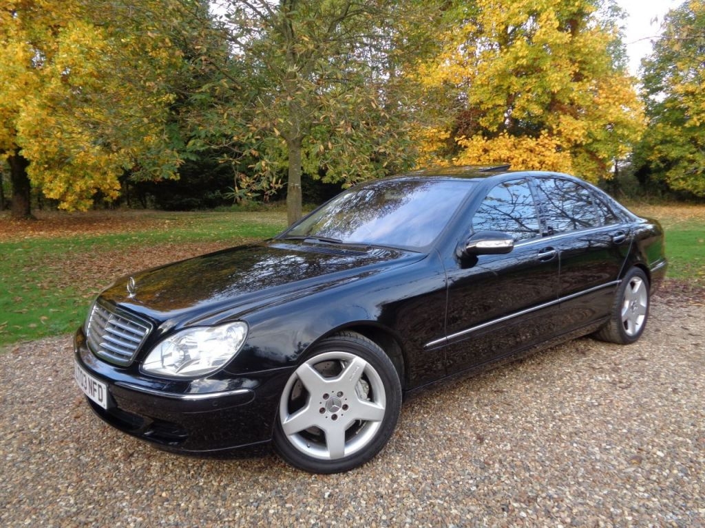 Lovely Cars: Interesting, Classic, Retro, Barge 5-10k - Page 99 - General Gassing - PistonHeads - This image captures a serene outdoor setting. Dominating the scene is a black Mercedes-Benz S-Class sedan, parked on a gravel driveway. The car is positioned at an angle that showcases its sleek design and alloy wheels, reflecting the sunlight off its glossy exterior. 

The car is surrounded by natural beauty, including tall trees that tower over the vehicle, casting dappled shadows. The gravel driveway underfoot is typical of a countryside or suburban setting. 

In the background, there is a glimpse of an orchard, with trees and foliage visible. The combination of the parked car, the orchard, and the driveway creates a picturesque outdoor scene that is both tranquil and attractive.