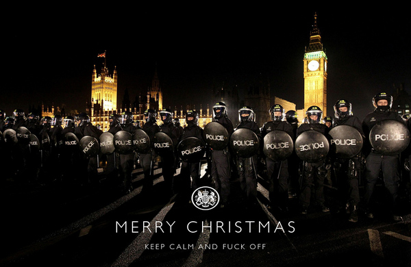 Pistonheads Students Ing Protest - This is a digitally manipulated image that merges the well-known iconography of a Christmas greeting with the appearance of a riot police force. At the center of the image is the text "Merry Christmas" in a white font. Flanking the text on the left and right are individuals dressed in black riot gear with helmets, some of whom are holding onto police shields. With the shields reading "POLICE," the image is mimicking the formality of a Christmas card with a festive message, but the presence of riot police instead of carolers creates a stark contrast likely meant to convey a statement about law enforcement or social unrest. In the background, silhouetted against a dark sky with a lit clock tower, the city of London can be seen, which aligns with the recognition of London as the traditional location for City of London Police. The overall tone of the image is serious and unconventional, as opposed to the typically celebratory and holiday-themed atmosphere one would expect.