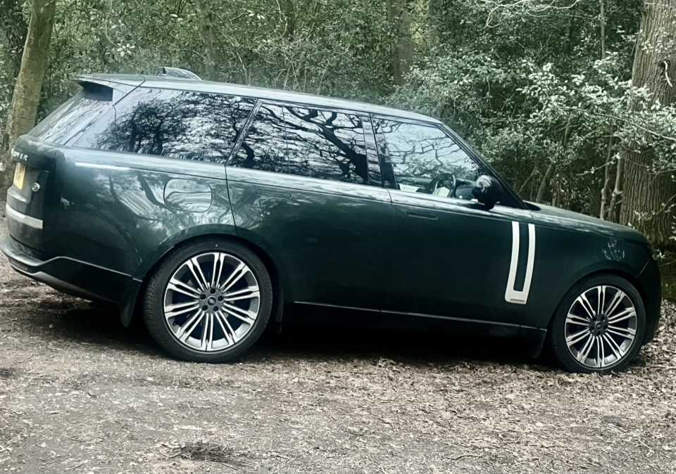 Pistonheads - The image shows a striking transformation. On the left side, there is a photograph of a green SUV parked in what appears to be a forested area. On the right side, the same image has been digitally altered. The car's bodywork is now entirely black, with white stripes running down its sides, adding a bold contrast to the original green color scheme. This gives the impression of a different vehicle altogether.