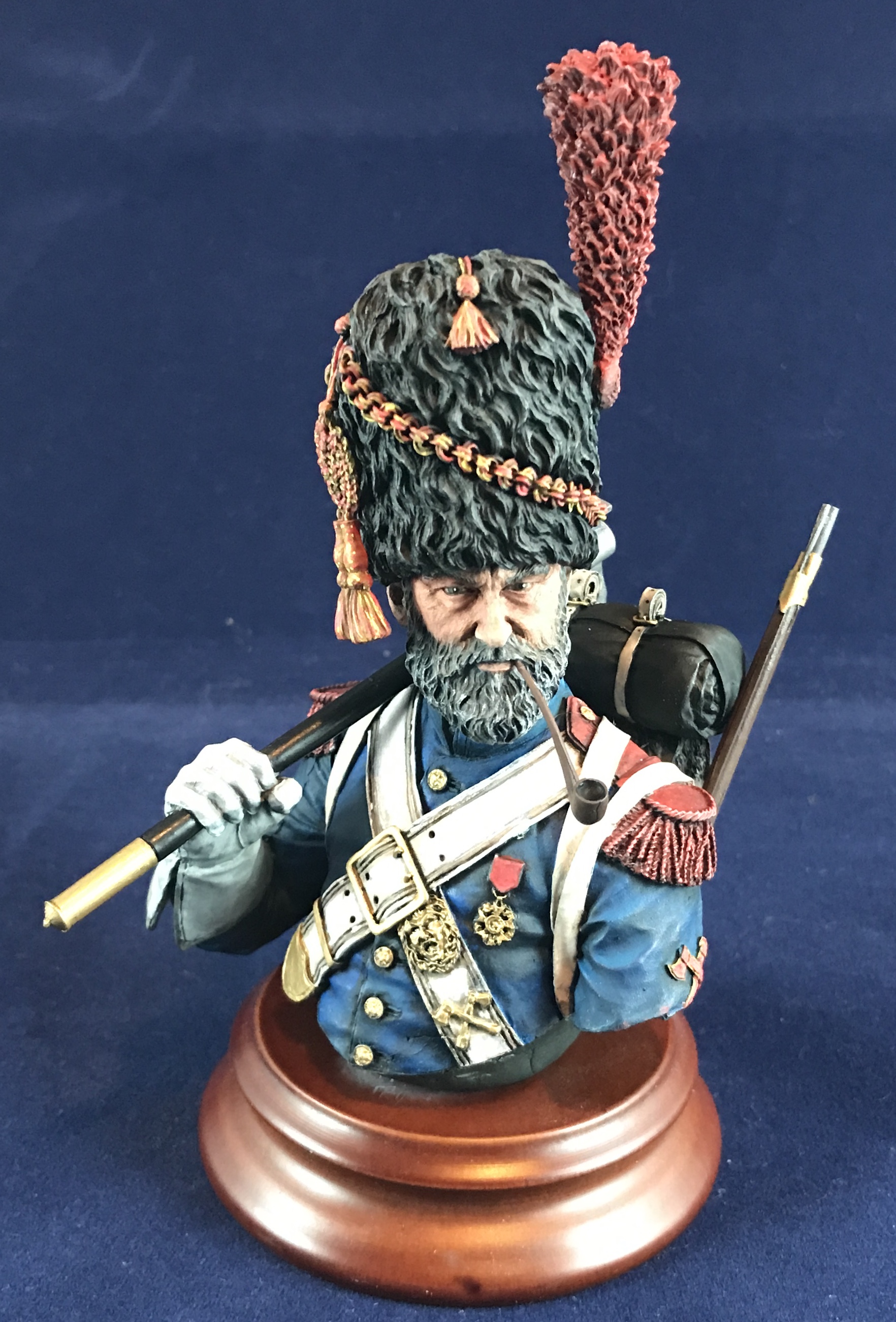 The thread where we can talk about painting figures. - Page 4 - Scale Models - PistonHeads - The image features a three-dimensional figurine of a man in military attire, specifically a general or high-ranking officer. He is wearing a red and gold uniform with a matching hat, which suggests a historical context or a representation of a famous commander from the past. In his left hand, he holds a sword, signifying his status as a warrior or leader. Additionally, there's a cane in his right hand, indicating a level of rank or status that requires such an accessory. The figurine is placed on a pedestal with a blue background, highlighting the figure for display purposes.