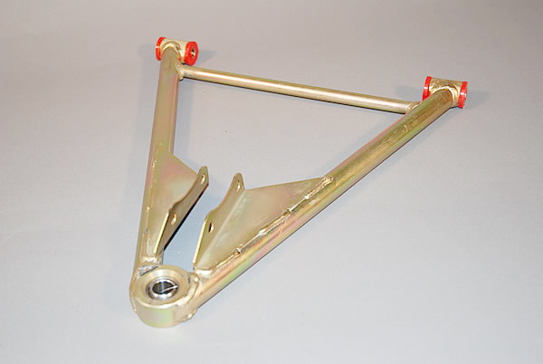 Spot Wishbones Difference Pistonheads - The image features a metallic clamp or bracket with a rubberized base, designed to secure a rod or similar object. The clamp is positioned diagonally across the frame, highlighting its L-shaped configuration. The base has red components, potentially screws or bolts. There's a notable metal rod through the center of the clamp. The background is a neutral gray surface, putting the focus on the industrial object.