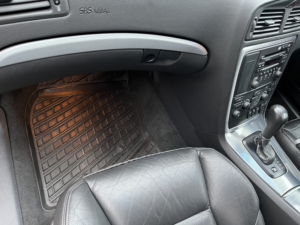 2005 Volvo V70 2.5T SE - Page 6 - Readers' Cars - PistonHeads UK - The image shows an interior view of a vehicle with the focus on the floor. A mat is placed under the passenger side pedals, which are visible in the center console area of the car. The mat appears to be designed for comfort and ease of use during driving. There's also a car seat in the foreground, suggesting that this is taken from inside a vehicle, possibly from the driver's perspective. The lighting in the image is such that the focus is on the floor, making it clear and well-lit.