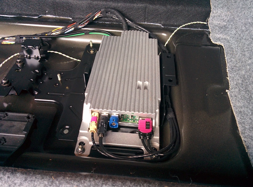 Terrible standard sound systems - Page 3 - In-Car Electronics - PistonHeads - This image captures the electric system of a vehicle, specifically focusing on the electrical box located beneath the dashboard. The box, painted in a metallic silver color, is lined with a black label that contains several different cables from various colors. These cables are interconnected, suggesting that they are part of a sophisticated configuation of the vehicle's electrical system. The precise positioning of the cables and connections within the box indicate a high level of organization and careful installation. The image serves as a detailed look into the mechanical design of a vehicle, highlighting the importance of electrical systems in modern-day automobiles.