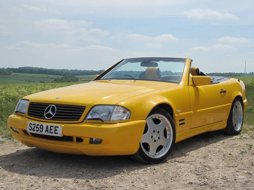 Best smoker barges 1-5 large [vol8] - Page 430 - General Gassing - PistonHeads - The image features a vibrant yellow Mercedes-Benz S229 AE Range Rover parked on a rocky surface with a scenic background. It's a daytime shot with a clear blue sky. The car has a distinctive large grille and is standing out against the rugged terrain. The hubcaps have a unique design with multiple holes around the circumference.