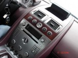 Pistonheads - The image shows a close-up view of a luxury car's dashboard, emphasizing its sleek design and advanced features. The dashboard is dominated by a chrome or metallic finish, giving it a modern and sophisticated look. A variety of buttons and dials suggest a high level of control and customization for the driver. There's a concentration on the center console, with a prominent display area, perhaps for a navigation system or central touch screen. The craftsmanship and attention to detail in the design of the car suggests a high-end or luxury vehicle.