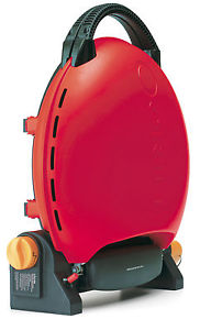 Small gas BBQ recommendations please - Page 1 - Tents, Caravans & Motorhomes - PistonHeads - The image shows a red-colored device with a handle-like attachment. The device appears to have a round, dome-shaped structure at the top and a black base with straps. Both the device and the attachment feature ventilation holes. The attachment appears to be a part of the device, considering it belongs to the same image, and it's positioned in a way that suggests it could be used in conjunction with the main unit. The device does not have any visible text or branding in the image. The style of the image is a straightforward product photograph, set against a plain background focused on showing the product clearly.