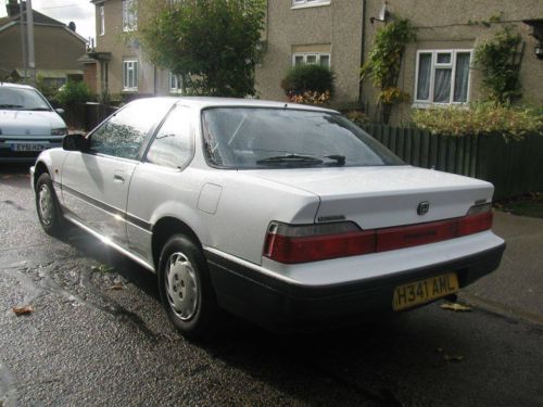 Pistonheads - This image shows a white car parked on a street. The car is possibly a Honda or Toyota model, as indicated by the badge on the trunk. The license plate is clearly visible and reads "H34 AMN." The location appears to be a residential area, with a trimmed garden visible in the background. The car's condition appears to be well-maintained, with clean bodywork and shiny paintwork.