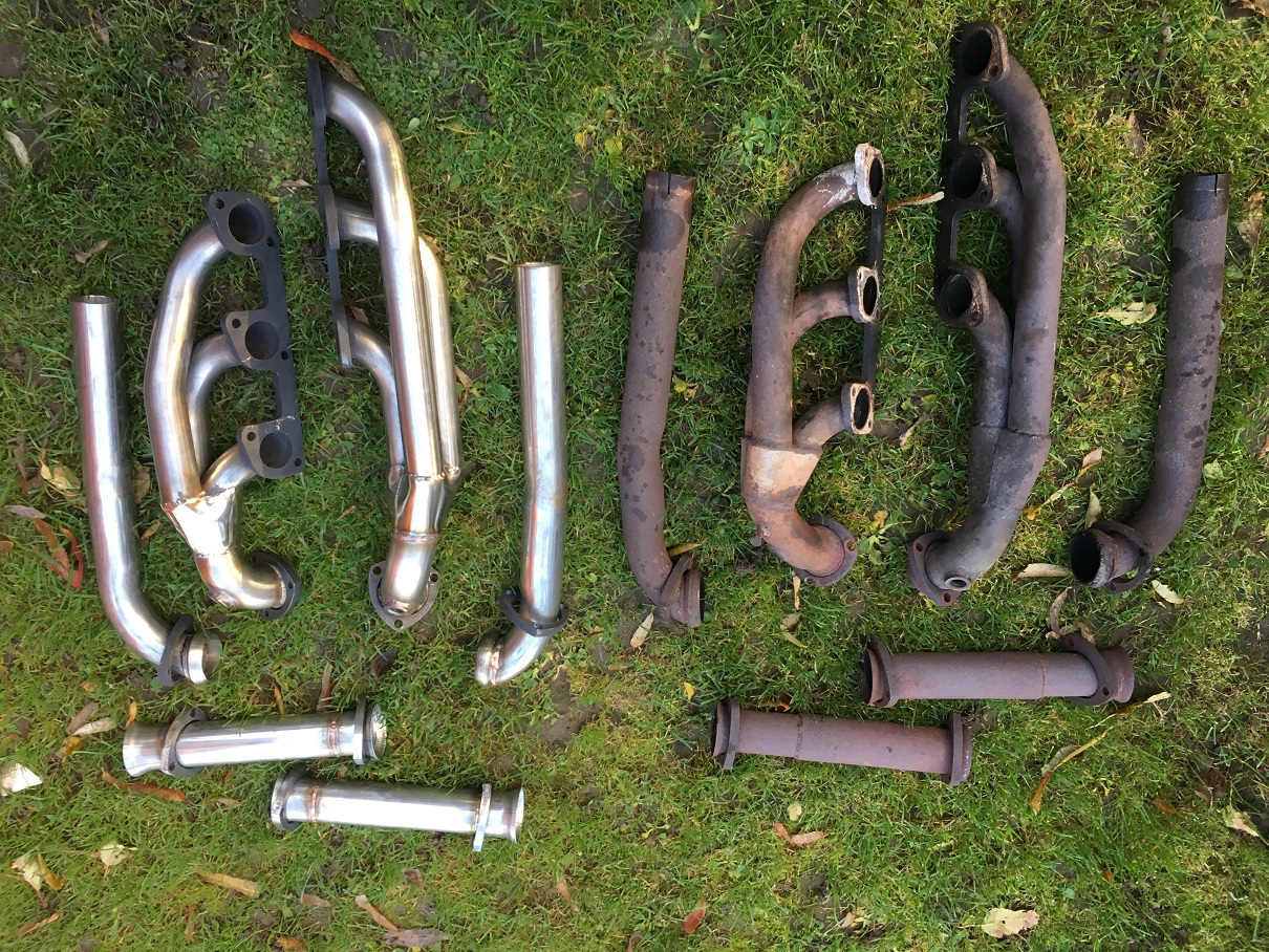 Random TVR pics - Page 470 - General TVR Stuff & Gossip - PistonHeads - The image shows a collection of automotive exhaust components laid out on a grassy surface. There are pipes and tubes of varying sizes and lengths, some appearing to be intact while others are fragmented. They reflect a slightly compacted appearance as though they have been used and discarded. The parts are spread out, with some overlapping and others forming loose groups. The image is taken from an elevated angle, capturing the details of the metallic components against the green background.