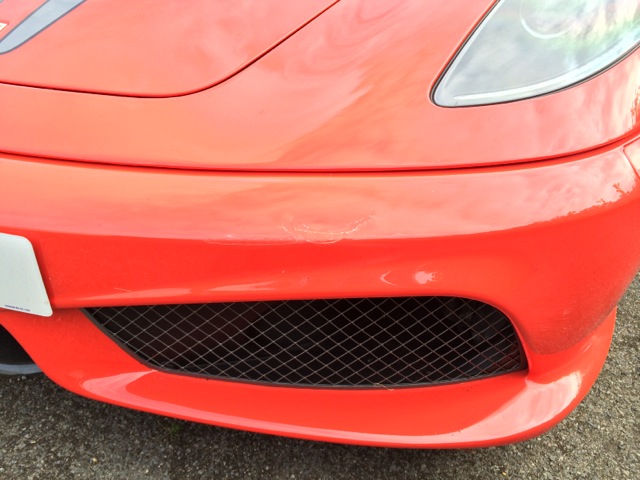 Kudos for guessing which classic supercar's.... - Page 1 - Ferrari V8 - PistonHeads - This is a close-up photo of the front of a Lamborghini car. The car is a rich red color with a shiny finish. It features a distinctive front grille with a honeycomb pattern that is characteristic of Lamborghini designs. The vehicle's headlight is prominently visible, positioned to the right of the photo. The Lamborghini logo is not visible in this image, so it does not provide any additional information about the car model.