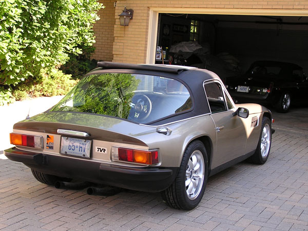 Early TVR Pictures - Page 90 - Classics - PistonHeads - The image portrays a classic silver car parked in a garage. The car, an older model, is adorned with a white license plate reading "TVR 857 HW". The interior of the garage provides a glimpse into the resting place of this vintage vehicle. Dominating one side of the frame is the garage door, ready for the vehicle's exit. Adjacent to the door, on the brickwork of the garage, sits a solitary black bird, perhaps seeking shelter or observing the world from its perch. The overall scene captures a moment of stillness, with the car being the main focus.