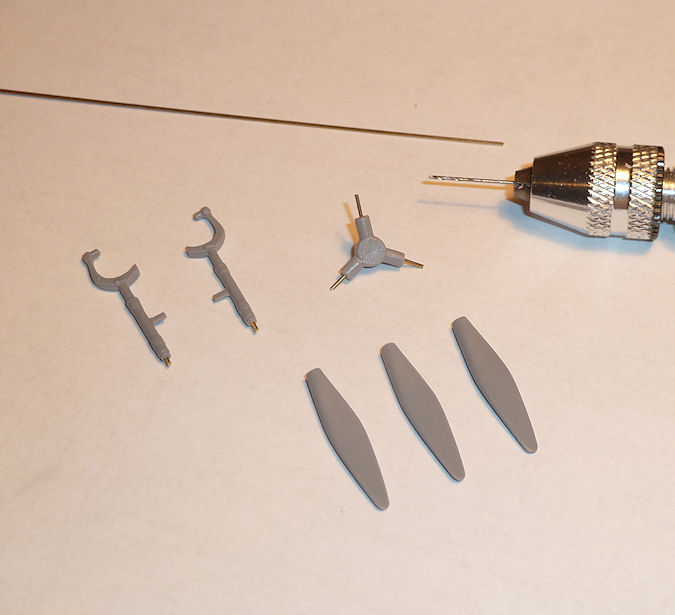 A pair of scissors sitting on top of a table - Pistonheads - The image shows a desk or tabletop with various flat, bendable metal objects scattered on it. Prominently displayed in the center of the image is a drill press, suggesting that the tools might be the output from this device. The tools have a metallic luster and are in the shape of gears or other mechanical components with flat surfaces and sharp edges. They are not positioned in a specific arrangement but rather appear randomly scattered across the table. The scene gives the impression of a workspace or hobby area where someone may be involved in metalworking or machine tools.