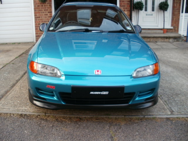 A blue car parked next to a parking meter - Pistonheads