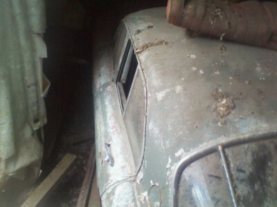 A close up of a luggage bag on the ground - Pistonheads - The image depicts an old, rusted car located within a room. The car, exhibiting a worn and aged look with signs of rust, is positioned in the middle of the scene. In the background, a curtain is partially visible, partially obstructing the view of the car. The surrounding room features a dark, possibly dirty or neglected ambiance, indicated by the overall opacity of the car frame and the curtain. The image appears to be of a standard photographic style, capturing the vehicle's state of disuse and the overall setting. There is no text present in the image.