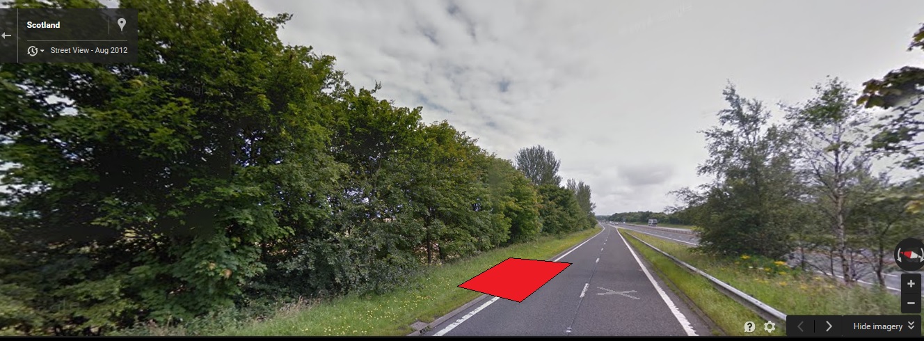 A stop sign on the side of a road - Pistonheads - The image appears to be a screenshot from a vehicle's navigation device. The device is displaying a section of a highway. There is a highlighted route indicated, leading from a current location labeled as Scotland, towards a point of interest called "Stirling Viewpoint," within the city of Stirling. The surrounding landscape is visible, featuring trees and possibly another highway running parallel or connected by a sideroad or exit.