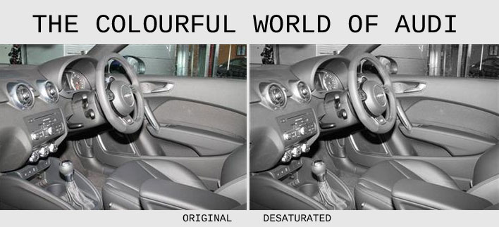 Pistonheads Holy Crap - The image is a side-by-side comparison of interior interiors, from the perspective of what is seen inside a car from the driver's seat. On both sides of the image is a photograph of a grey car's dashboard and steering wheel area, but the left side is original and the right side is desaturated. Behind the steering wheel and dashboard, there's a vehicle interior that appears to be a car show room, with visible artificial lighting and reflected surfaces.