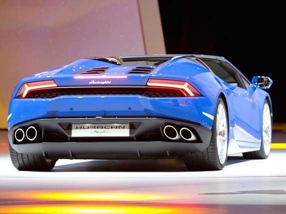 A Boyhood Dream Realised... - Page 2 - Gallardo/Huracan - PistonHeads - The image features a luxurious sports car on display at an auto show. The car is primarily in shades of blue, with a design that emphasizes aerodynamics. It has a distinctively futuristic look, with sleek lines and a low center of gravity, enhanced by its low-slung stance. The vehicle's design elements and the indoor setting suggest it's a concept car designed for high performance and style.