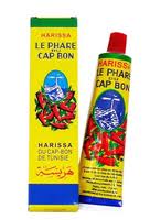 Pistonheads - The image features a bottle of Harissa Le Phare Capsicum Bon, standing upright against a plain background. The label on the bottle is predominantly yellow with blue and red accents. The text on the label indicates that the product is a Harissa Cap Bon. Additionally, the label depicts a graphic of green phare caps advancing downward along with a bouquet of chili peppers. The overall appearance of the container suggests it is used for manufacturing replacement parts for machinery or equipment, possibly considering the invasive cutting or incision tasks as Phare means treachery in French.