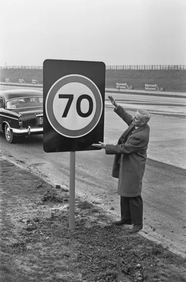 A man standing next to a stop sign - Pistonheads