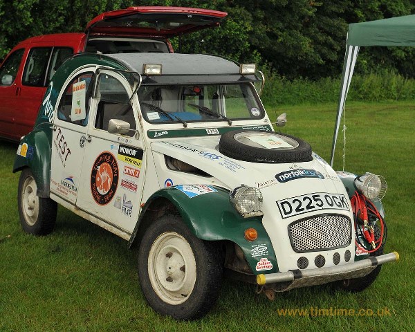 2CVGB Registers Day 2012  - Page 1 - Photography & Video - PistonHeads - This image shows a vintage car with the hood open, parked in a grassy area. The car is predominantly white with a green roof and distinctive black tires. The body of the car features a variety of logos and decals, and the registration plate is clearly visible. The style of the car suggests it could be a classic model from the mid-20th century. A small tent can be seen behind the car, suggesting that this could be an outdoor event or exhibition.