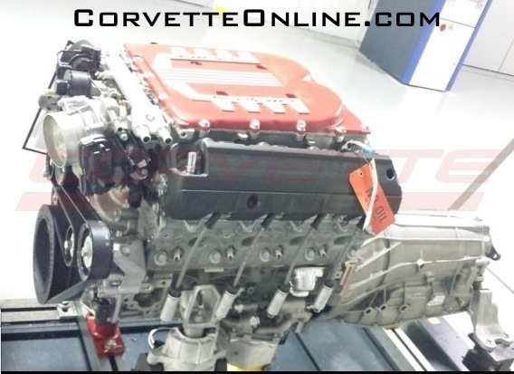 C7 Z0? Mule - Page 1 - Corvettes - PistonHeads - The image shows a Corvette engine on a table with a hood open to reveal the engine's components. The engine has no visible damage and appears to be a modern, high-performance unit, as indicated by the presence of intake and exhaust components and the labeling of various parts. The photo has a watermark that includes the domain name "CorvetteOnline.com," suggesting it may be used for an online marketplace or resource related to Corvettes. The LED lights in the background provide illumination, highlighting the details of the engine.