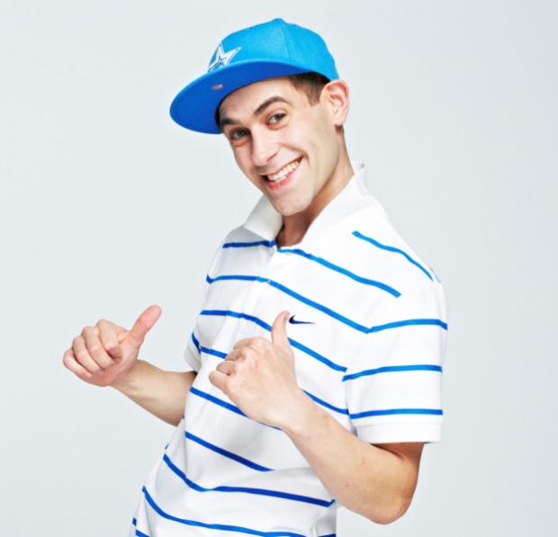 Show us your new shoes - Page 495 - The Lounge - PistonHeads - This is a close-up photograph of a young man. He is wearing a white polo shirt with blue and white stripes. He has his right arm extended pointing upward, with his fist clenched, indicating a flexing or victory pose. His facial expression is one of a wide smile, and he seems to be looking directly at the camera. The background of the image is plain and light, providing a clear focus on the man.