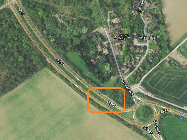 Pistonheads - The image is an aerial view of a roadway intersection. There is distinct marking on the ground and white text labels the roads. An orange area highlights a particular section of the highway. The landscape is surrounded by green fields and there is a sign indicating the name of a nearby street. The overall environment suggests a rural to semi-rural setting.