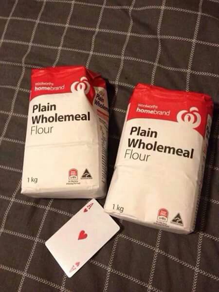 Sean Connery Joke Thread (Vol 9) - Page 443 - The Lounge - PistonHeads - The image presents a scene of two packs of "plain wholemeal flour" and a single playing card resting on a bedspread. The flour bags, with their bold red, white, and yellow labels, are the most prominent objects in the scene, taking up a significant portion of the image. The playing card, lying within the square formed by the flour bags, introduces a contrasting recreational element to the otherwise domestic environment. The bedspread, visible in the background, provides a soft, neutral base that grounds the image.