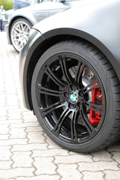 RE: PistonHeads Sunday Service: 25/07/10 - Page 9 - Events/Meetings/Travel - PistonHeads - The image features a close-up view of a BMW car's right front tire and wheel. The car appears to be parked on a brick pavement against a clear sky background. The tire has a distinctive tread pattern while the wheel features a shiny metallic finish with a logo in the center, suggesting a state-of-the-art design. The overall scene is bright and suggests a clean and well-maintained vehicle.