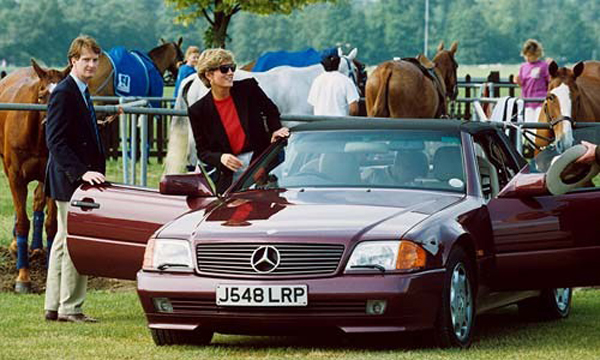 4 seats in an SL? - Page 1 - Mercedes - PistonHeads - The image depicts a tranquil scene in a field where two men are interacting with a vintage red Mercedes-Benz convertible. One man is standing by the open door of the car, while another man, positioned to the left of the frame, is exiting the vehicle. The men are dressed neatly and professionally, suggesting a significant event or occasion.

In the background, several horses are visible, grazing or walking leisurely in the field. A couple of people are also scattered around, possibly attendees of the event. The horses and people add a touch of rustic charm to the overall ambiance.

The setting seems to be outdoors, with livestock and a vintage vehicle indicating that the event could be related to agriculture, a classic car exhibition, or a combination of both.

The image captures a moment of interaction between the vintage car and its operators, reflecting a contrast between the industrial design of the vehicle and the natural, pastoral surroundings.