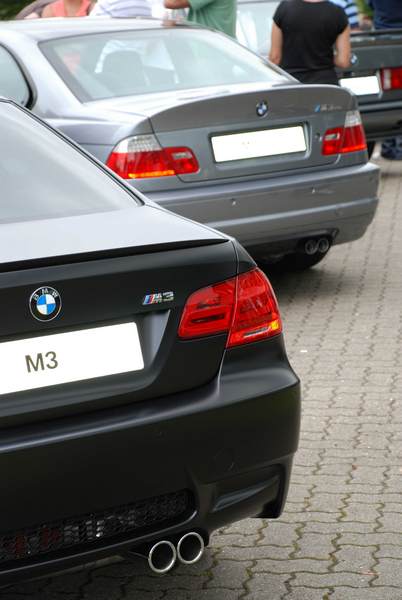 RE: PistonHeads Sunday Service: 25/07/10 - Page 9 - Events/Meetings/Travel - PistonHeads - The image presents a side view of a black BMW 3 Series parked in a parking lot. The car has a visible license plate on the right side. In the background, there are two other cars, although their details and makes are not discernible. The ground appears to be paved, providing a stable surface for the vehicles. The image itself has a candid quality to it, suggesting it may have been taken casually or informally.