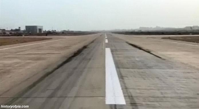 A320 down in Pakistan - Page 4 - Boats, Planes & Trains - PistonHeads - The image is a photograph of an airport runway captured from the perspective of an airplane window. The scene shows a clear sky, suggesting good weather conditions, and the runway appears to be well-maintained with clearly marked lines. There's a visible white stripe indicating the centerline of the runway, which is a standard feature in many airport runways for guidance during takeoff and landing. The image has text overlaying it, but the specific content of the text is not clear from this perspective.