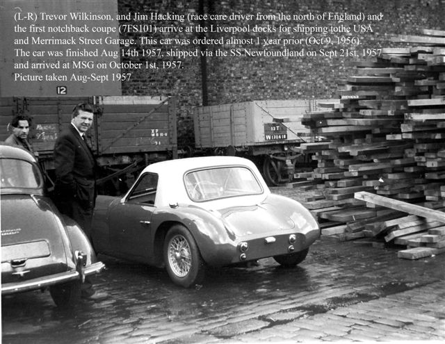 Early TVR Pictures - Page 33 - Classics - PistonHeads - The image is a black and white historical photograph. It features a man standing next to a tractor trailer with the registration plate "8". Behind him, a white sports car is parked, and the surrounding scene includes various shipping crates and textures, possibly a dock or port area, indicating transportation and manufacturing. The text within the image provides information about a notable car owner from the north of England, and mentions a specific date range, August 1957 to October 1957. The image has a vintage look, suggesting it is from around the mid to late 20th century.