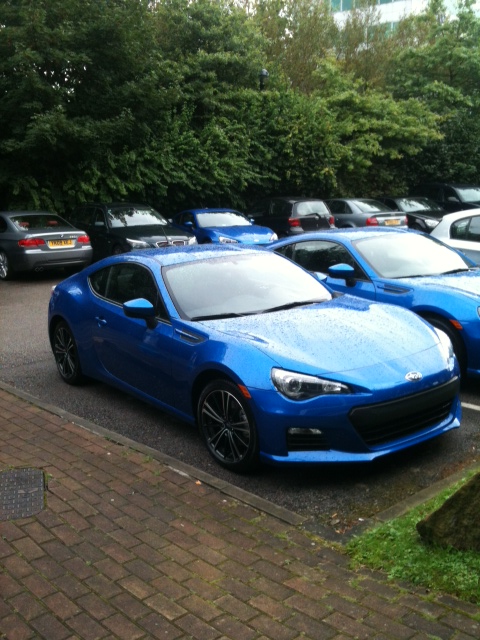 A blue car parked next to a red car - Pistonheads