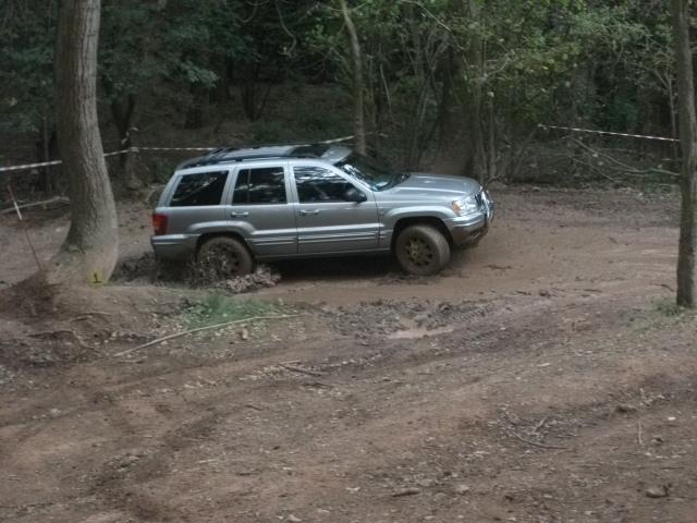 My previous off roaders  - Page 1 - Off Road - PistonHeads - The image shows a silver SUV parked on a dirt road. The vehicle appears to be partially stuck in the mud, with one of its wheels sinking in. Sunlight is casting shadows on the ground, suggesting it's during the day, and the surrounds are wooded, indicating a forested area. There are no people visible in the image. The style of the photo is candid and seems to capture a moment of a vehicle experiencing troubles in an off-road situation.