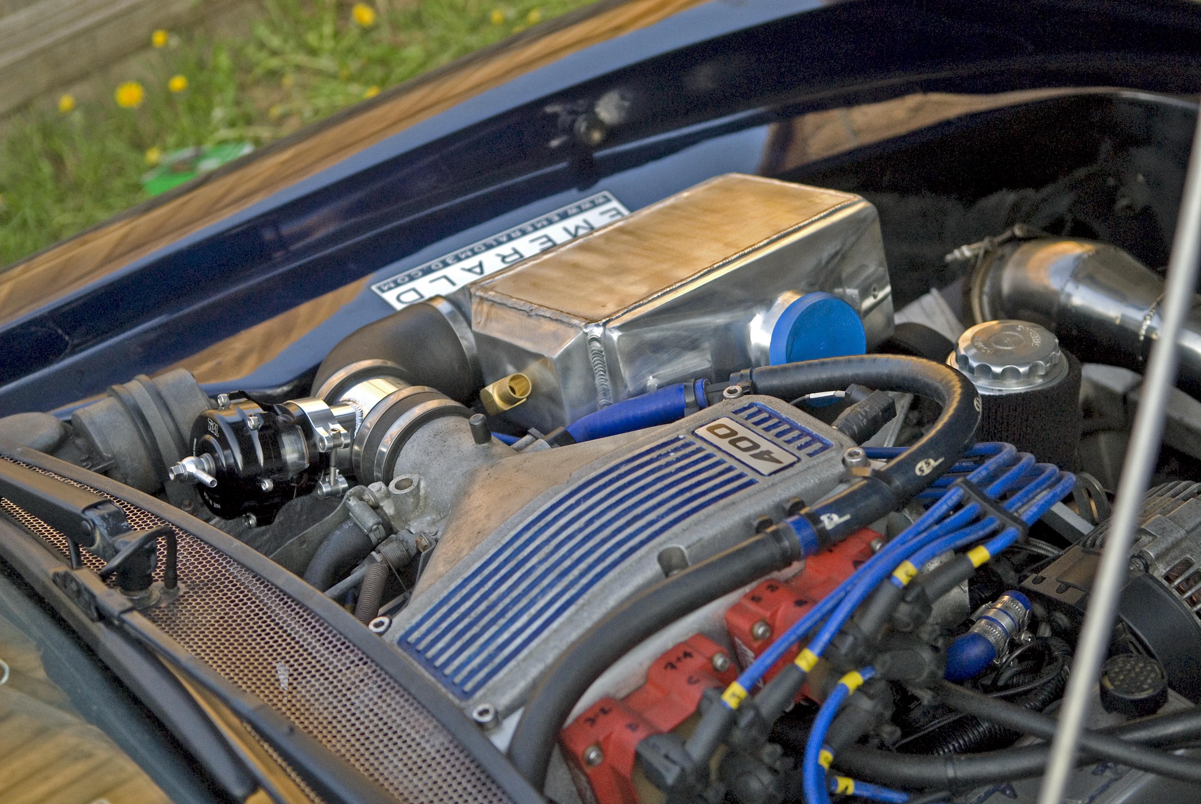 What did you do in the garage yesterday? - Page 71 - Chimaera - PistonHeads - The image gives a close-up view of the under-the-hood of a vehicle, focusing on the engine. The engine bay is filled with large mechanical components, including what appears to be a silver fan and a blue oil cooler, components that you would typically find in a vehicle's engine compartment. The positioning of various parts is carefully arranged, with the fan placed above the engine, and the oil cooler nearby, designed to keep the engine at an optimal temperature. The image captures the complexity of the vehicle's engine, a testament to the precision and engineering that goes into its construction.