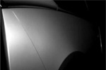 Pistonheads - The image showcases a close-up view of a silver car panel. The panel reflects the contrast between light and shadow, creating a textured pattern. There is a reflection on the surface of the panel, adding depth to the image. The background appears to be dark, which accentuates the metallic sheen of the car panel. The focus is solely on the car panel, emphasizing its importance.