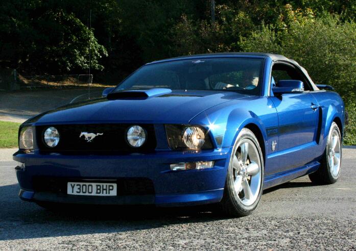 Photoshoots of their car in Kent (Madistone) area.  - Page 3 - Kent & Essex - PistonHeads - The image shows a sleek and shiny blue sports car parked on a concrete surface. It sits with a black top, distinguishing it from other models.