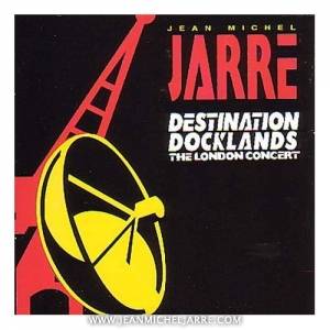 Michel Pistonheads Jarre Jean - The image features a graphic design or album cover with the name "JARRE" prominently displayed at the top in white uppercase letters. Below the artist's name, the text "DESTINATION DOCKLANDS" appears, suggesting the title of the album. Beneath this, the name "THE LONDON CONCERT" is presented, indicating the nature of the performance. The visual art suggests a blend of industrial and concert themes, with silhouettes of what seem to be radio towers or antennas at the top and a depiction of a transmission satellite or satellite dish in the middle. The overall color scheme is a simple contrast of black and white, with the earth-toned satellite also having a yellowish hue that stands out against the background.