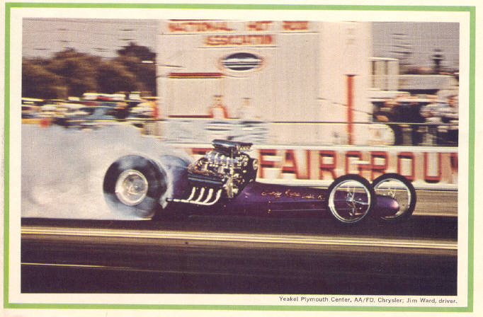 A black and white photo of a police car - Pistonheads - The image showcases a hybrid drag racing car, featuring a license plate placeholder text "YEAK PLYMOUTH CENTER, AAF/DOC, JIM WARD, DRIVER." The car is predominantly purple with black and white accents, and is emitting a significant amount of smoke due to its high-performance engine. The setting appears to be a drag racing strip with spectators in the background. The photo captures the tailslide moment of the race car, adding a dynamic element to the scene.