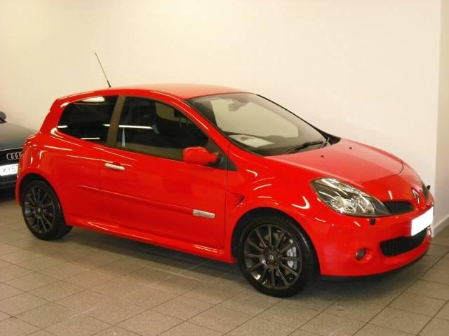 Pistonheads - The image shows a red car parked in a garage. It's a vibrant red color and appears to be a compact model, possibly a hatchback. The body of the car looks well-maintained, with glossy paint and a clean finish. The surroundings include a concrete floor and a white wall, typical of a garage or showroom setting. The car has a license plate on the back, but the plate number is not clear due to distance and angle.