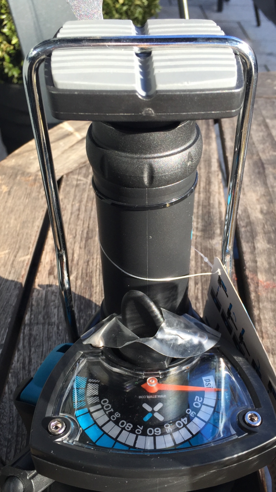 The "what bike bits have you just bought" thread - Page 304 - Pedal Powered - PistonHeads - The image shows a close-up of a black and blue kitchen scale. The scale is sitting on a gray surface, likely a kitchen island or countertop. The silver-colored base connects to a slight incline and is topped by a large clear round bowl where the weight would be displayed. There is a coffee cup with a black lid next to the scale. A white label appears to be present on the piece of equipment, but the details on the label are blurred.