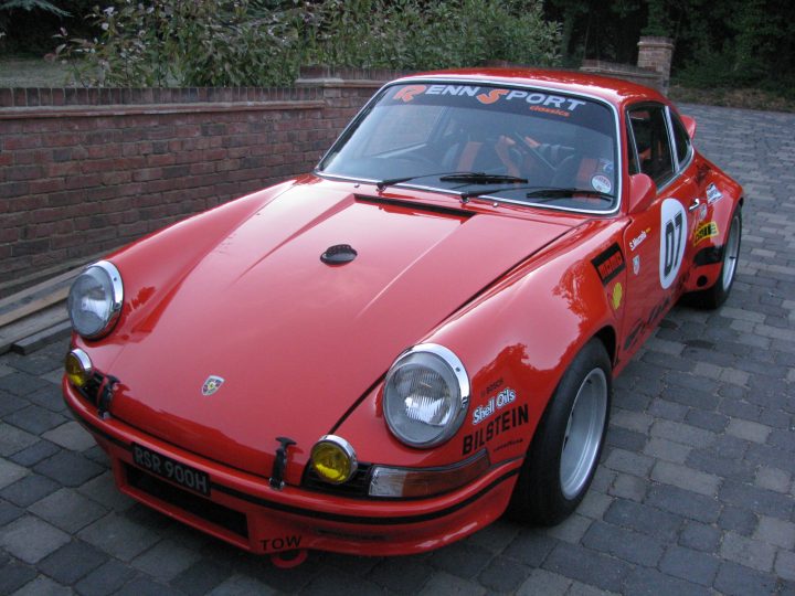 What's the consensus on well built replicas?  - Page 1 - Porsche Classics - PistonHeads - The image showcases an orange racing car parked on a brick pavement. The car, in excellent condition, is a 1983 Porsche 914. It's characterized by its black roof, yellow lights, and silver accents. The wedding decal on the windshield suggests that it might be a special vehicle, perhaps linked to a celebration or event.