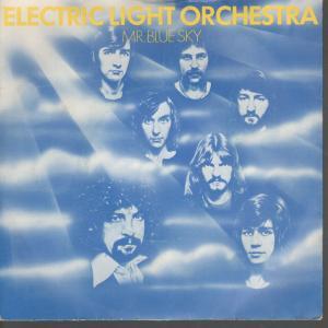 Top Ten Singles Pistonheads - The image features an album cover for "Electric Light Orchestra". The main theme is a sunlit sky, with rays of light beaming down, creating a warm and serene atmosphere. A group of musicians, known as The Electric Light Orchestra, consist of two men with long hair and two men with shorter hair, all seemingly silhouetted against the bright backdrop. The album is called "Mr. Blue Sky", with the name prominently displayed at the bottom. The cover art is simple yet striking, effectively conveying a sense of energy and light through its use of color and symbolic imagery.