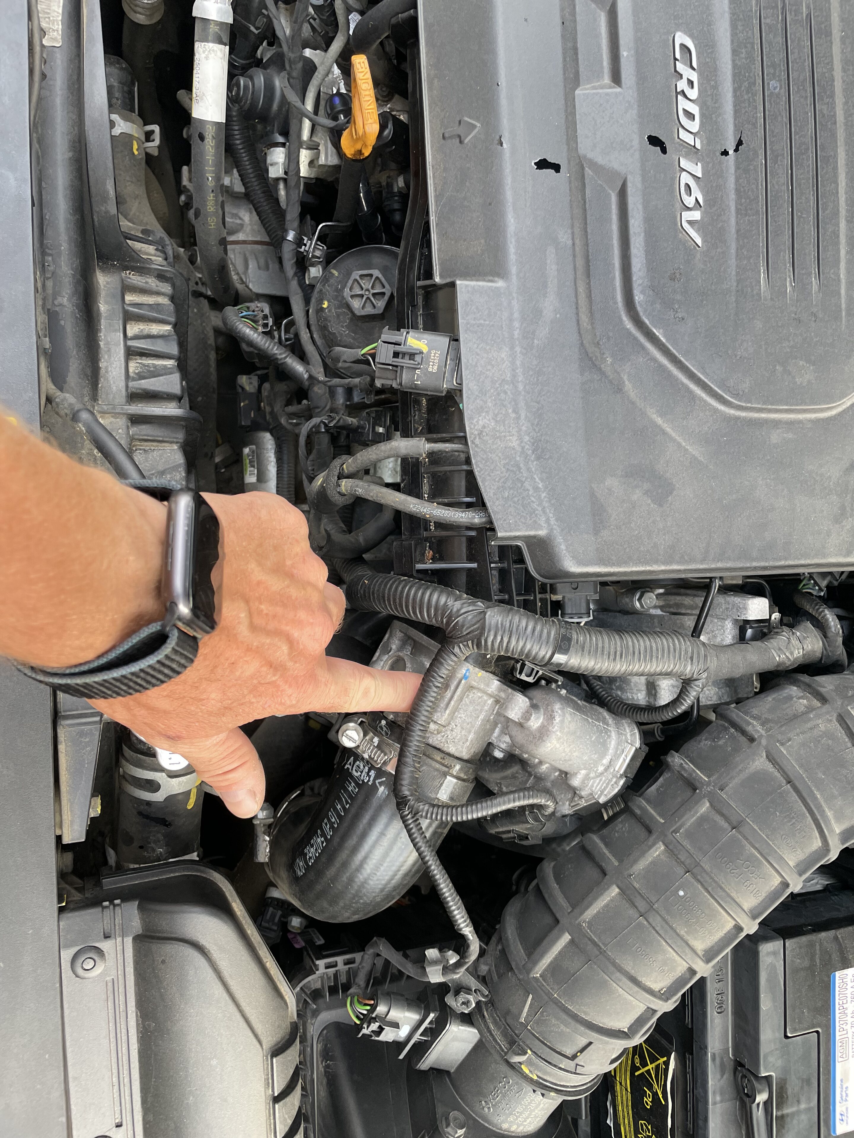 Pistonheads - The image shows a person standing next to a car with the hood open. The individual is holding a tool, likely inspecting or working on the engine. The car appears to be in a state of disassembly, indicating that maintenance or repairs are being carried out. There's no text visible in the image. The focus is on the activity of fixing or inspecting the vehicle, with attention drawn to the tools and mechanical components exposed during this process.