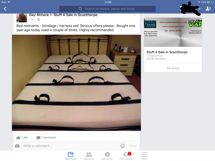 A laptop computer sitting on top of a bed - Pistonheads - The image shows a bed with black straps laid out on it, set in a room with a desk visible in the background. There's a text post overlaid on the image with information that includes bondage, BDSM in Sunderland, and mentioning "Stuff4Sale" and "Stuff4Sale in Sunderland." The post includes a hashtag calling the group "Highly Recommended by Gaz Atmore." The date on the post is said to be one year ago, and the conversation includes "Like," "Comment," and a red heart emoji. The top left corner of the image indicates the time "21:02."