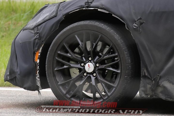 C7 Z0? Mule - Page 1 - Corvettes - PistonHeads - The image is a high-resolution, full-color photograph showing a close-up view of the front wheel of a vehicle. The wheel is dark, suggesting it could be black, and is out of focus, providing a sense of depth. The hood of the car is visible and appears to be black, reinforcing the monochromatic aesthetic of the scene. In the bottom right corner of the image, there is a text logo with the letters "KGAS" and the word "photography" in lowercase. This suggests that the image may be associated with a photography or automotive business. The focus of the image is the wheel and the surface of the car, indicating attention to detail with respect to the vehicle's design and appearance.